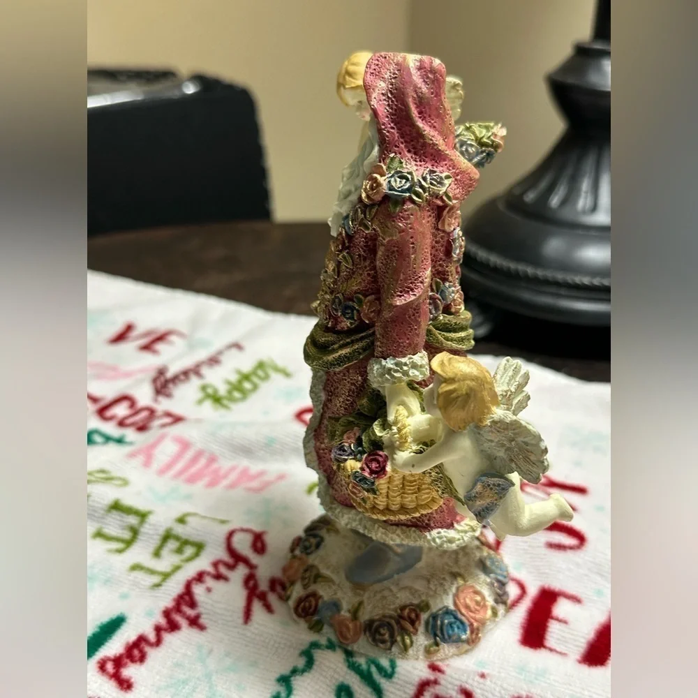 Festive Santa Figurine with Cherubs